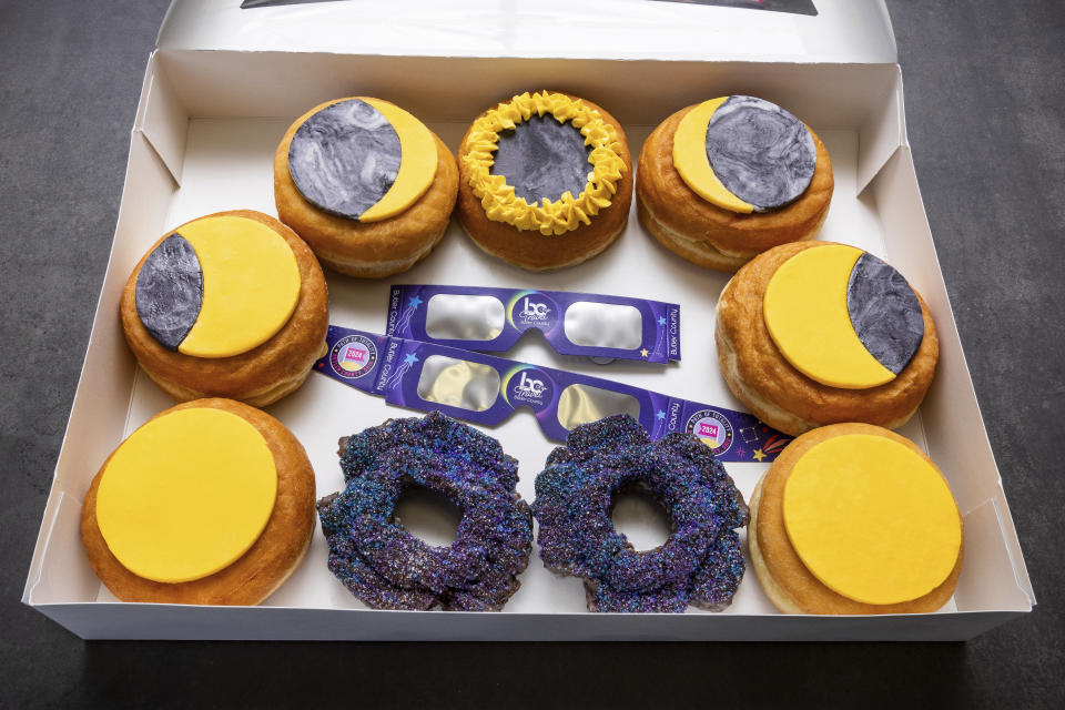 A box of donuts arranged to represent phases of an eclipse is displayed at the Donut Dude shop on Friday, March 8, 2024 in Liberty Township, Ohio. Businesses are capitalizing on the April 8 , 2024, solar eclipse expected to dim skies across a generous stretch of North America. (Travel Butler County/RVP Photography via AP)