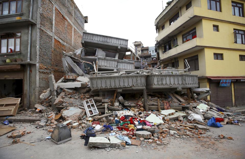 A collapsed building is pictured after an earthquake hit, in Kathmandu, Nepal April 25, 2015. The shallow earthquake measuring 7.9 magnitude struck west of the ancient Nepali capital of Kathmandu on Saturday, killing more than 100 people, injuring hundreds and leaving a pall over the valley, doctors and witnesses said. REUTERS/Navesh Chitrakar TPX IMAGES OF THE DAY