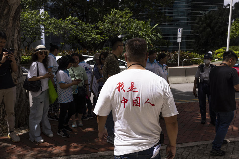 A pro-China protester leaves a mini protest with a shirt reading "I am Chinese" after the British government criticised the arrest warrants issued for 8 pro-democracy activists living in the United States, Britain, Canada and Australia for alleged national security offenses in Hong Kong, Thursday, July 6, 2023. (AP Photo/Louise Delmotte)