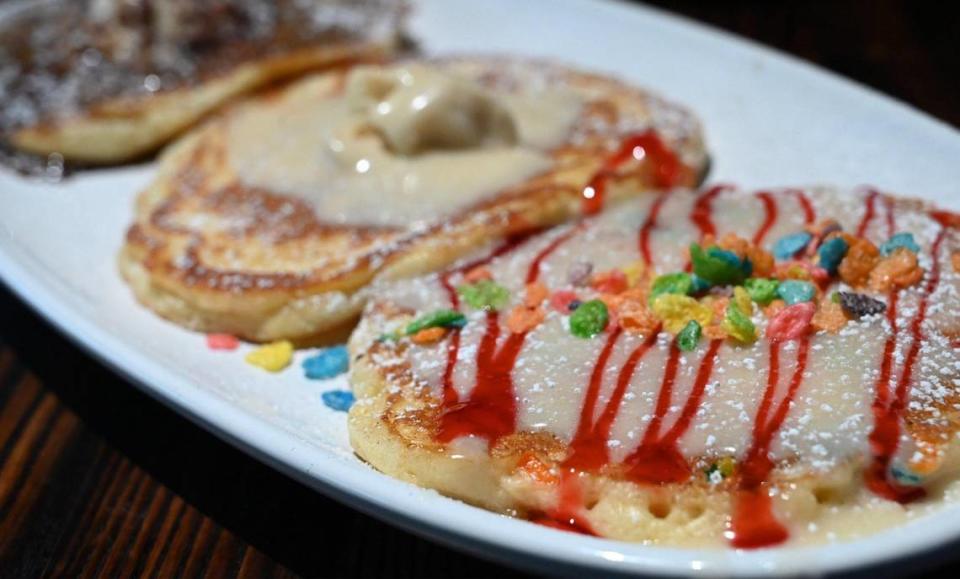 The Woodward American Grill offers a pancake flight, with the customer’s choice of three pancakes. Featured in this photo, rainbow pancakes, followed by a pineapple upside-down pancake and a cinnamon swirl pancake in the background, photographed Wednesday, April 26, 2023 in Fresno. The Woodward has opened in the RiverView Shopping Center at Ft. Washington and Friant Rd.