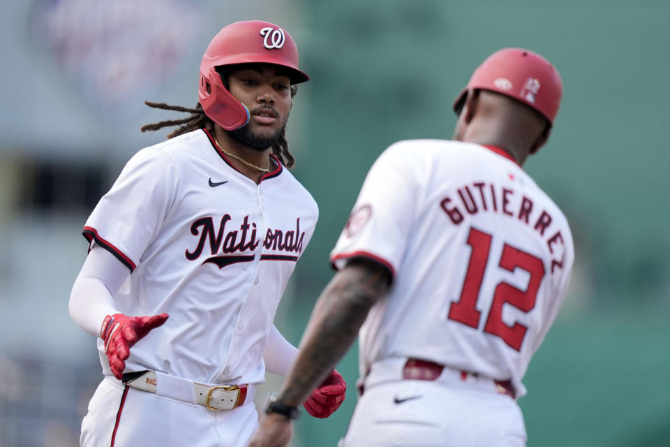 Washington Nationals' James Wood, left, is congratulated by third base coach Ricky Gutierrez after hitting a three-run home run during the second inning of a baseball game against the St. Louis Cardinals at Nationals Park, Saturday, July 6, 2024, in Washington. (AP Photo/Mark Schiefelbein)