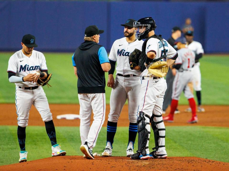 Miami Marlins starting pitcher Pablo Lopez (49) talk with pitching coach Mel Stottlemyre Jr., catcher Jacob Stallings (58) and Miguel Rojas (11) during the second inning of a baseball game against the Washington Nationals at LoanDepot Park on Wednesday, May 18, 2022 in Miami, Florida..