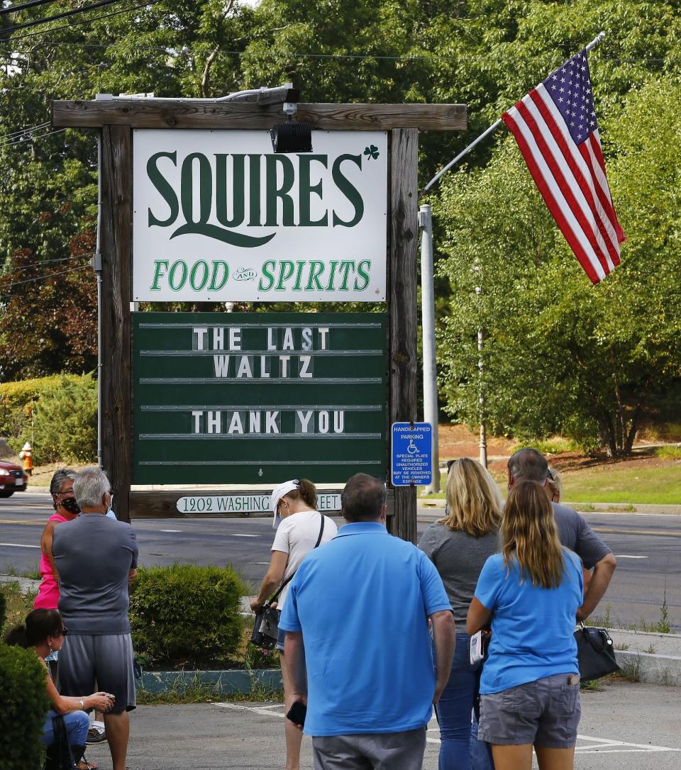 Patrons line up outside Squires to get a table before the restaurant closed.