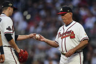 Atlanta Braves pitcher Tucker Davidson, left, hands the ball to manager Brian Snitker, right, after being relieved in the third inning of a baseball game against the Philadelphia Phillies, Monday, May 23, 2022, in Atlanta. (AP Photo/John Bazemore)
