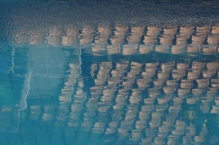 2016 Rio Olympics - Diving - Final - Women's Synchronised 10m Platform - Maria Lenk Aquatics Centre - Rio de Janeiro, Brazil - 09/08/2016. Empty seats are reflected in the water of the diving pool this morning REUTERS/Reinhard Krause