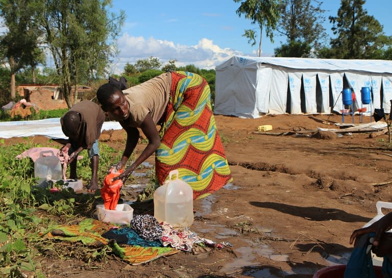 Burundian refugees wash clothes at a temporary shelter at the Gashora refugee camp in Rwanda