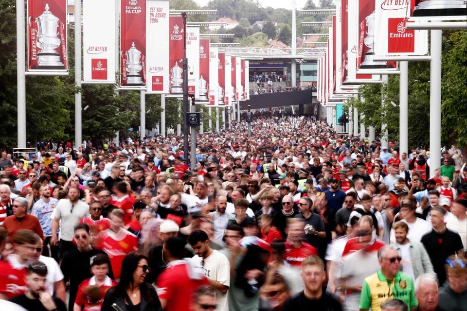 Fans make their way to Wembley Stadium   (AFP via Getty Images)