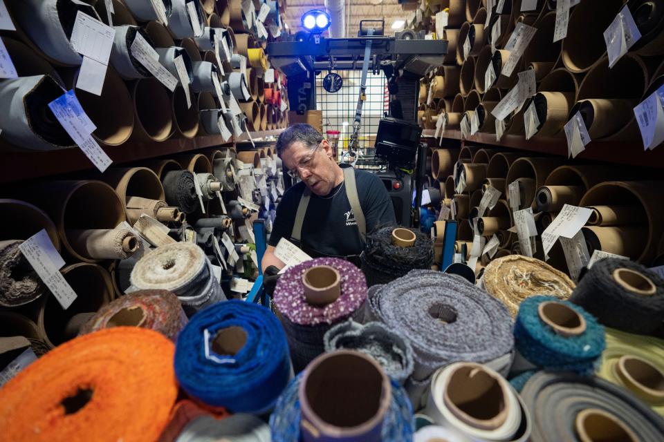 Micheal Weber retrieves rolls of fabric at Krueger International Inc. in Green Bay, Wis. The company specializes in furniture for educational institutions and offices.