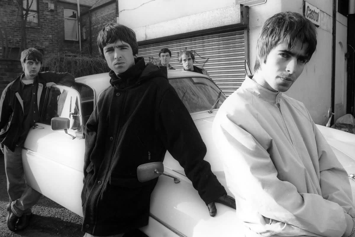 Manc motor mouths: Oasis (from left, Paul McGuigan, Noel Gallagher, Tony McCarroll, Paul ‘Bonehead’ Arthurs and Liam Gallagher) commandeer a Jaguar XJ6 for a November 1993 shoot (Getty)