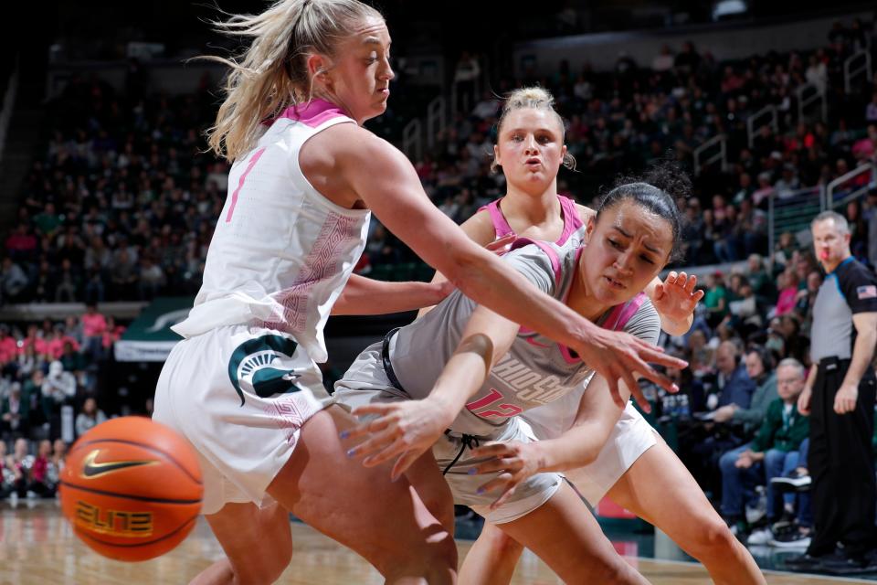 Ohio State guard Celeste Taylor passes against pressure from Michigan State guards Tory Ozment, left, and Theryn Hallock on Sunday.