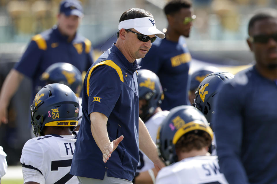 West Virginia head coach Neal Brown talks to the team before an NCAA college football game against Central Florida , Saturday, Oct. 28, 2023, in Orlando, Fla. (AP Photo/Kevin Kolczynski)