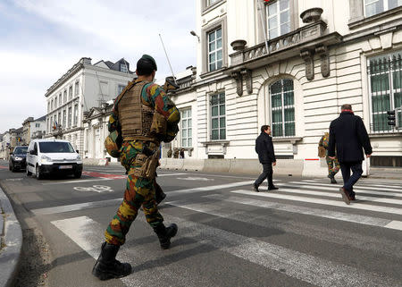 A Belgian soldier patrols outside the Belgian Parliament in Brussels, Belgium, March 23, 2017. Reuters/Yves Herman