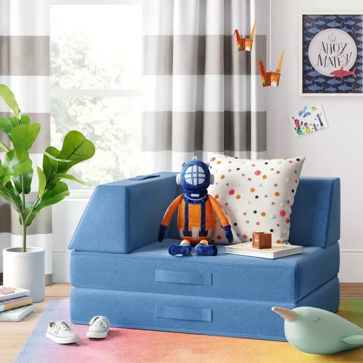the blue play couch in a room