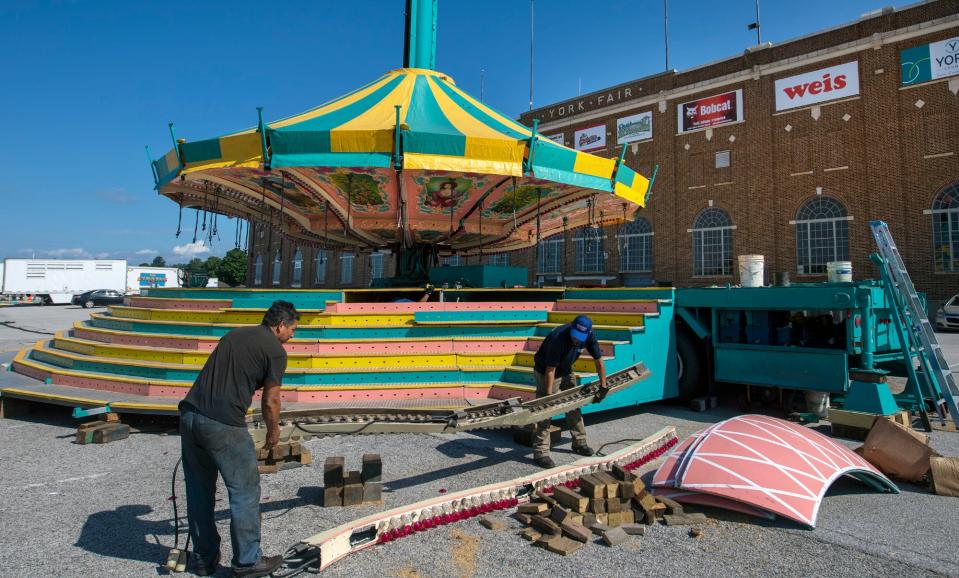 Workers set up The Swings ride at the York State Fair recently, in preparation for opening day, Friday July 23. Dozens of rides from a new vendor, Strates Shows, will fill up the entire midway. This will be a much earlier start for the annual event, which previously took place in September.