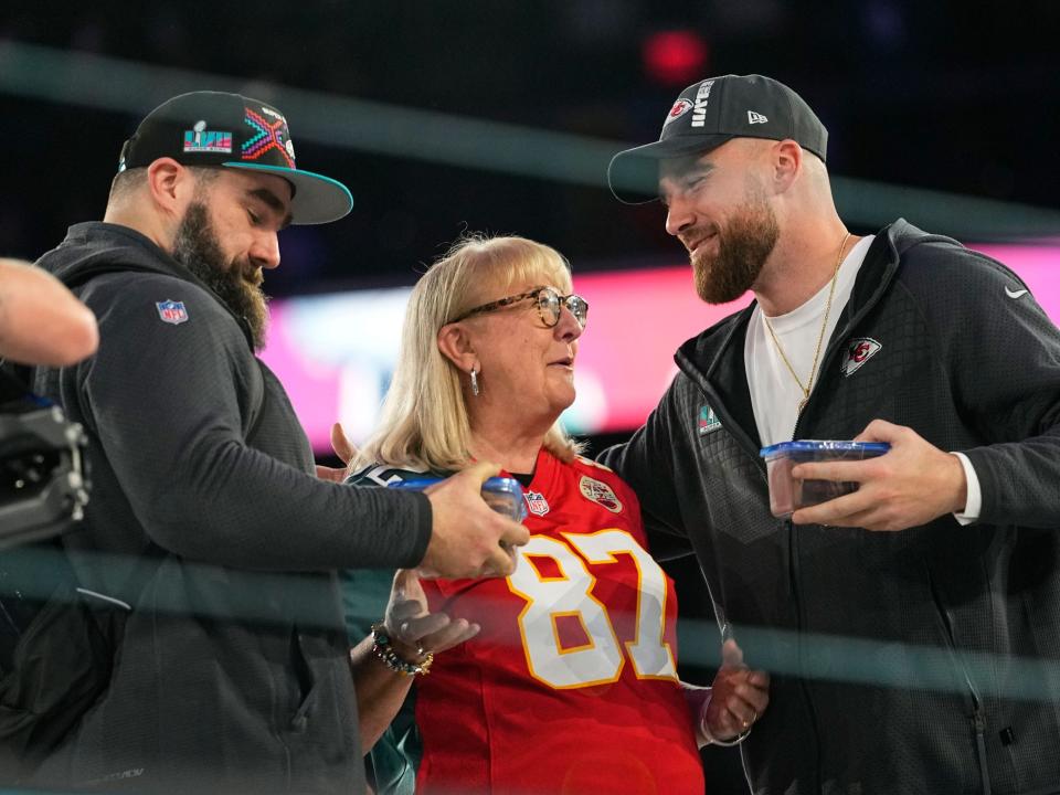 Donna Kelce greets her sons, Philadelphia Eagles center Jason Kelce, left, and Kansas City Chiefs tight end Travis Kelce during the NFL football Super Bowl 57 opening night.