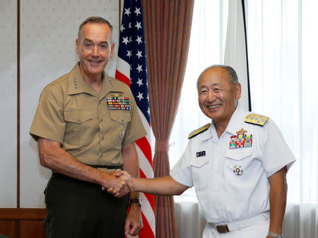 General Joseph F. Dunford, Jr., US Chairman of Joint Chiefs of Staff, shakes hands with Japan's Chief of Staff of Joint Staff Katsutoshi Kawano (R) at the start of their talks at the Defense Ministry in Tokyo, Japan, 18 August 2017. REUTERS/Kimimasa Mayama/Pool