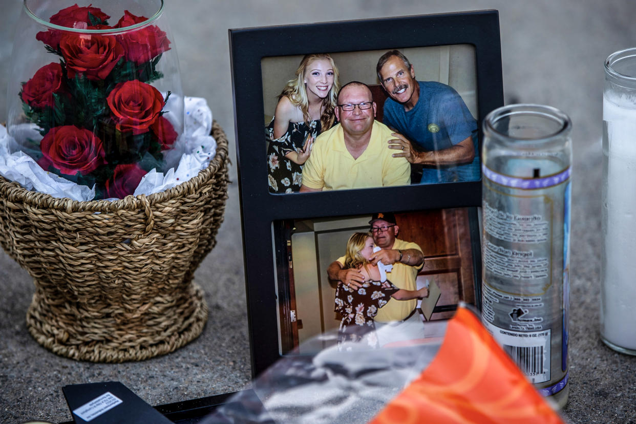 Family photographs part of a memorial in the driveway at the home where three family members were murdered, on Nov. 29, 2022 in Riverside, Calif. (Gina Ferazzi / Los Angeles Times via Getty Images)