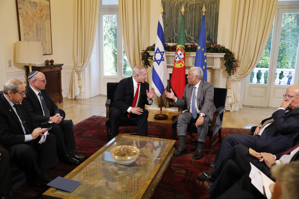 Israeli Prime Minister Benjamin Netanyahu, center left, and Portuguese Prime Minister Antonio Costa meet at the Sao Bento palace in Lisbon Thursday, Dec. 5, 2019. At right is Portuguese Foreign Minister Augusto Santos Silva. (AP Photo/Armando Franca)