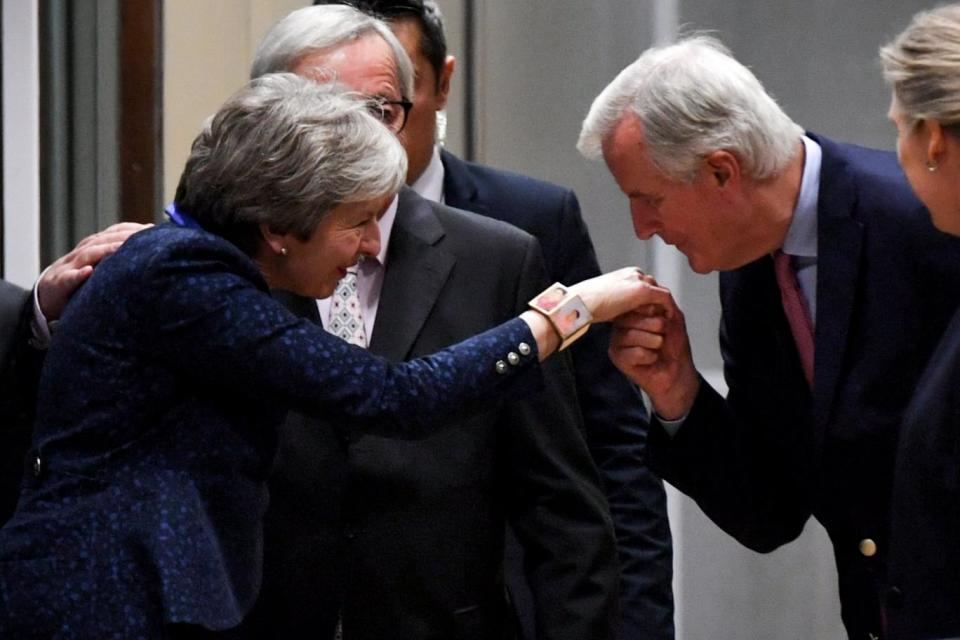 Prime Minister Theresa May is greeted by the EU's chief negotiator Michel Barnier on Saturday night (EPA)