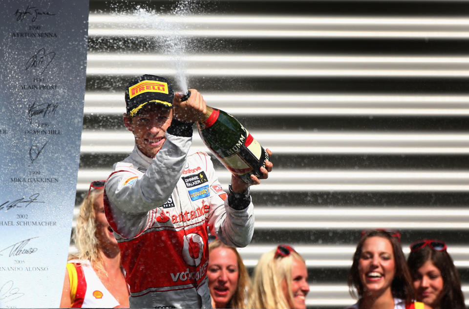 SPA, BELGIUM - SEPTEMBER 02: Jenson Button of Great Britain and McLaren celebrates on the podium after winning the Belgian Grand Prix at the Circuit of Spa Francorchamps on September 2, 2012 in Spa Francorchamps, Belgium. (Photo by Clive Mason/Getty Images)