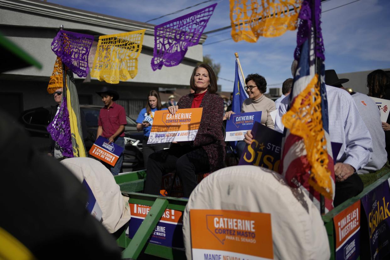 Sen. Catherine Cortez Masto rides on a trailer at a horse parade to get out the vote in Las Vegas on Saturday.  (John Locher / AP)