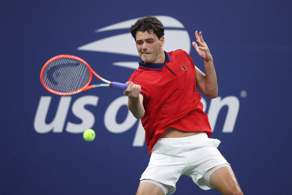 Pictured here, Taylor Fritz returns the ball against Alex de Minaur during their US Open clash.
