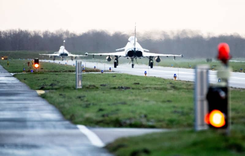 Two Eurofighter Typhoon fighter planes of the German Air Force fly over the tarmac at Wittmundhafen airbase. A Russian reconnaissance aircraft flying without a detection signal was spotted over the Baltic Sea off Germany, prompting fighter jets to be scrambled. An emergency patrol was sent up from the Laage Air Base in north-eastern Germany, the Luftwaffe said on 30 January. Hauke-Christian Dittrich/dpa