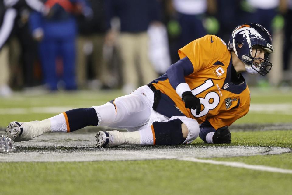 Denver Broncos' Peyton Manning lies on the ground after being tackled during the second half of the NFL Super Bowl XLVIII football game against the Seattle Seahawks Sunday, Feb. 2, 2014, in East Rutherford, N.J. (AP Photo/Julio Cortez)