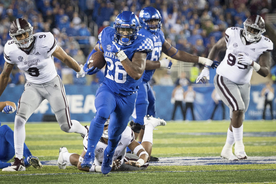 Kentucky running back Benny Snell Jr. (26) avoids the tackle of several Mississippi State players and runs for a touchdown during the second half in Lexington, Kentucky, on Sept. 22, 2018. (AP Photo/Bryan Woolston)
