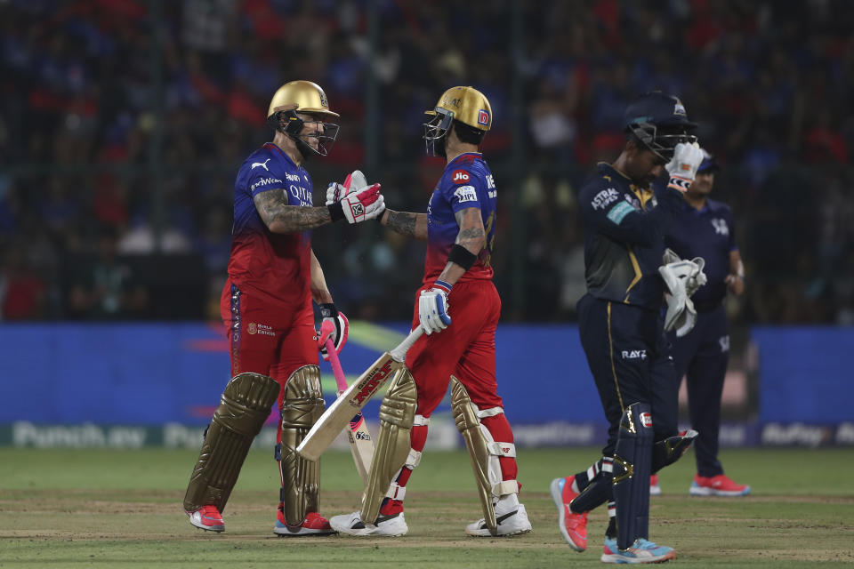 Royal Challengers Bengaluru's Virat Kohli congratulates captain Faf du Plessis on scoring 50 runs during the Indian Premier League cricket match between Royal Challengers Bengaluru and Gujarat Titans in Bengaluru, India, Saturday, May 4, 2024. (AP Photo)