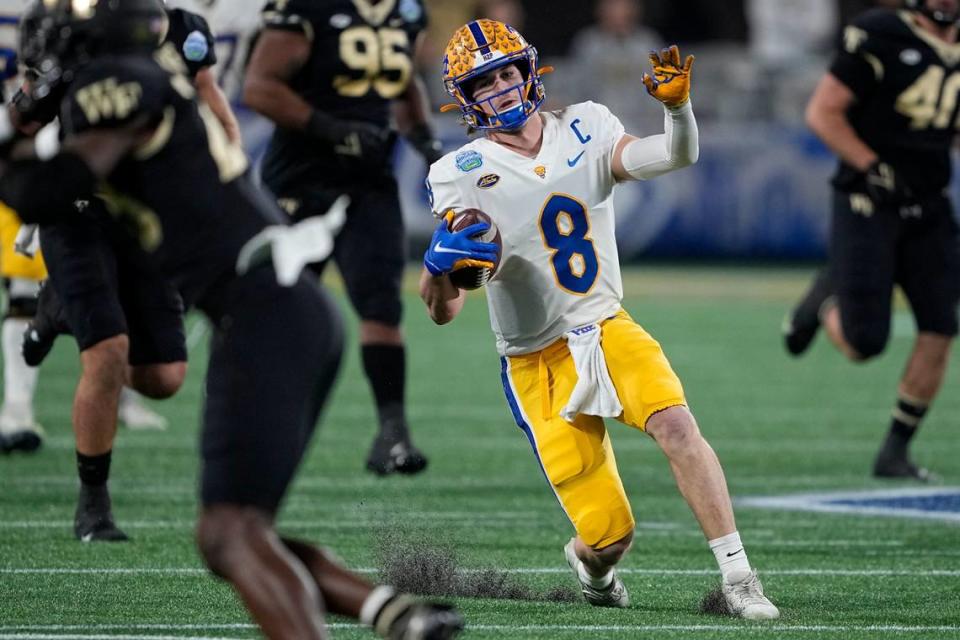 Pittsburgh quarterback Kenny Pickett fakes a quarterback slide, digging his right toe into the artificial turf as if he is going down, before rising back up and finishing a 58-yard touchdown run against Wake Forest during the first quarter of the Atlantic Coast Conference championship NCAA college football game Saturday, Dec. 4, 2021, in Charlotte, N.C. Pitt won, 45-21.