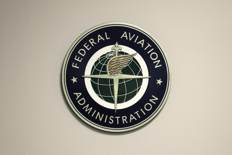 FILE - A Federal Aviation Administration sign hangs in the tower at John F. Kennedy International Airport, March 16, 2017, in New York. The Senate voted 98-0 to approve Michael Whitaker, President Joe Biden’s nominee to lead the Federal Aviation Administration, Tuesday, Oct. 24, 2023, ending a span of nearly 19 months in which the agency was without a Senate-confirmed chief. (AP Photo/Seth Wenig, File)