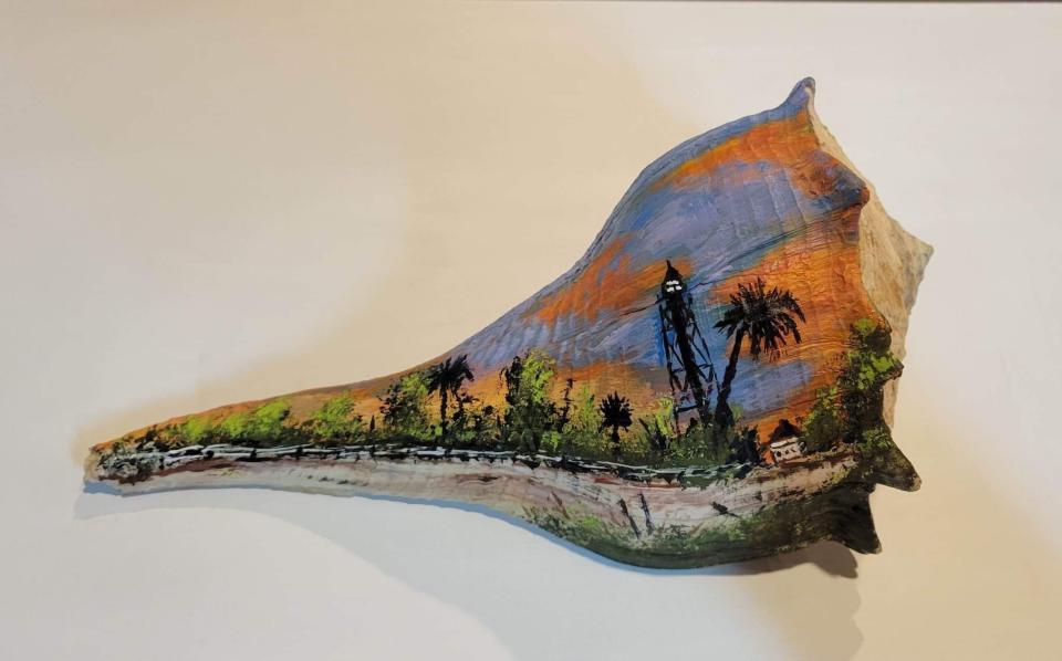 One of the whelk shells with a scene of Sanibel's Lighthouse Beach painted by Lyn Bowen-Radcliff.