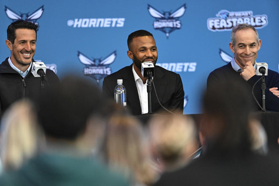 Jeff Peterson, center, new executive vice president of basketball operations, is flanked by team owners Gabe Plotkin, left, and Rick Schnall during an NBA basketball press conference to introduce Peterson Wednesday, March 6, 2024, in Charlotte, N.C. (AP Photo/Matt Kelley)