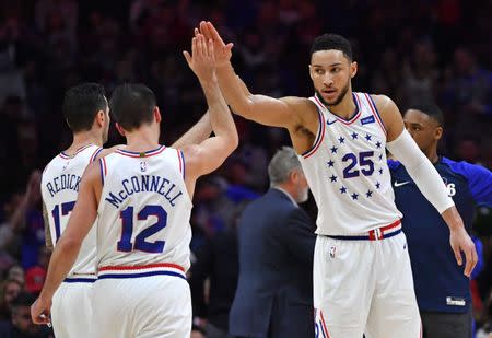 Jan 5, 2019; Philadelphia, PA, USA; Philadelphia 76ers guard T.J. McConnell (12) and guard Ben Simmons (25) high five against the Dallas Mavericks during the second quarter at Wells Fargo Center. Mandatory Credit: Eric Hartline-USA TODAY Sports