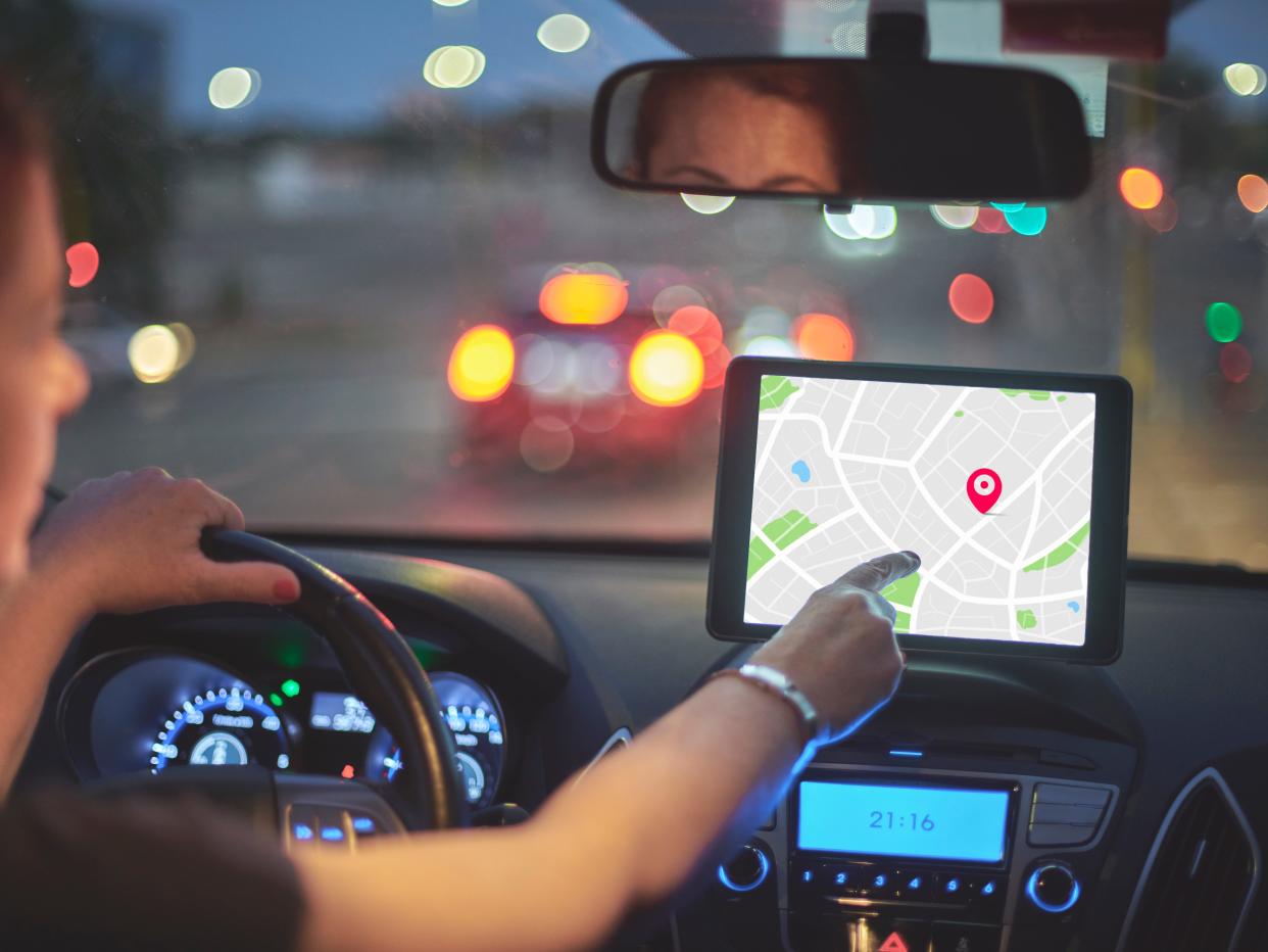 A woman following a navigation system in her car.