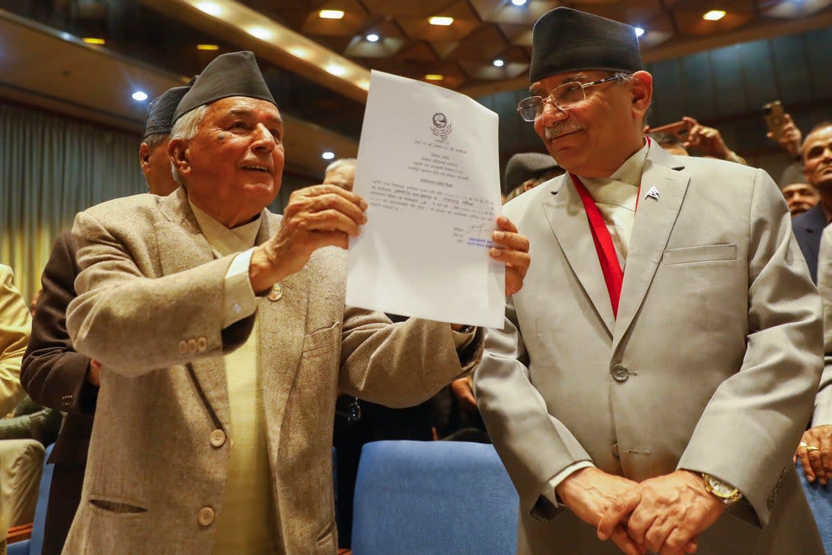 File. Nepalese Prime Minister Pushpa Kamal Dahal, right, looks on as Ram Chandra Poudel of the Nepali Congress party, left, shows his candidacy papers after filling his nomination to become Nepal's next president as in Kathmandu, Nepal, Saturday, 25 February 2023 (AP)