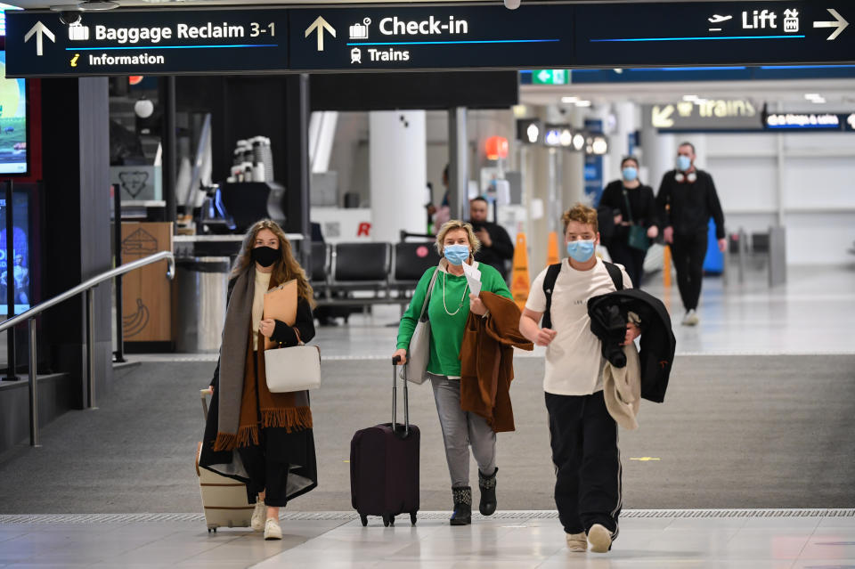 SYDNEY, AUSTRALIA - JULY 07: Passengers arrive in the baggage reclaim hall at Sydney Airport on one of the last flights out of Melbourne to Sydney on July 07, 2020 in Sydney, Australia. The NSW-Victoria border will close at 11:59pm on Tuesday evening due to a large spike in COVID-19 cases in Victoria. It is the first time in 100 years the border between the two states has been closed, and comes after Victoria recorded its highest-ever daily increase in cases, 127, since the start of the pandemic on Monday, along with the deaths of two Victorian men. From 12:01 Wednesday 8 July, NSW residents returning from Victoria will need to self isolate for 14 days. Special provisions will be in place for border communities such as Albury-Wodonga as well as freight operations and other critical services. (Photo by James D. Morgan/Getty Images)