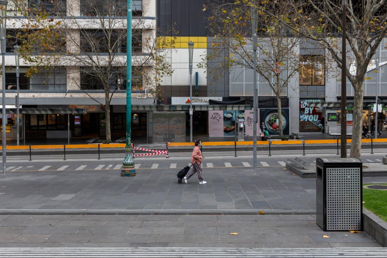 A lone shopper walks along a quiet Swanston Street in Melbourne, Australia: Getty Images