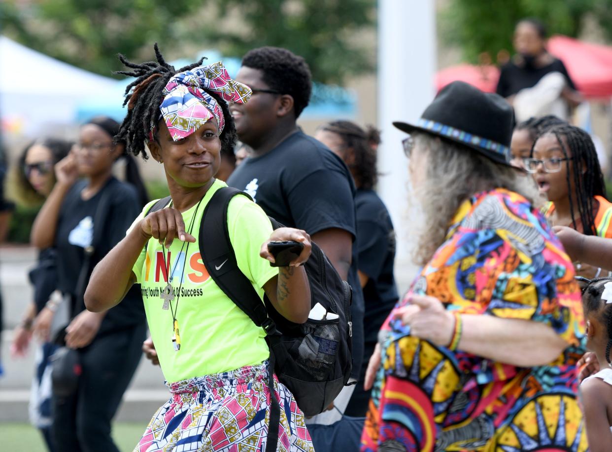 Tina Stevens of Canton joins in a dance Friday during EN-RICH-MENT'S third annual African American Arts Festival at Centennial Plaza in Canton.