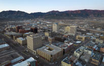 This aerial image taken with a drone, shows downtown buildings Wednesday, Nov. 23, 2022, in Colorado Springs, Colo. With a growing and diversifying population, the city nestled at the foothills of the Rockies is a patchwork of disparate social and cultural fabrics. But last weekend’s shooting has raised uneasy questions about the lasting legacy of cultural conflicts that caught fire decades ago and gave Colorado Springs a reputation as a cauldron of religion-infused conservatism, where LGBTQ people didn't fit in with the most vocal community leaders' idea of family values (AP Photo/Brittany Peterson)