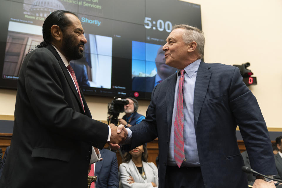 Crypto exchange FTX CEO John Ray, right, shakes hands with committee member Rep. Al Green, D-Texas, as he arrives to testify before the House Financial Services Committee on the collapse of crypto exchange FTX, Tuesday, Dec. 13, 2022, on Capitol Hill in Washington. (AP Photo/Manuel Balce Ceneta)