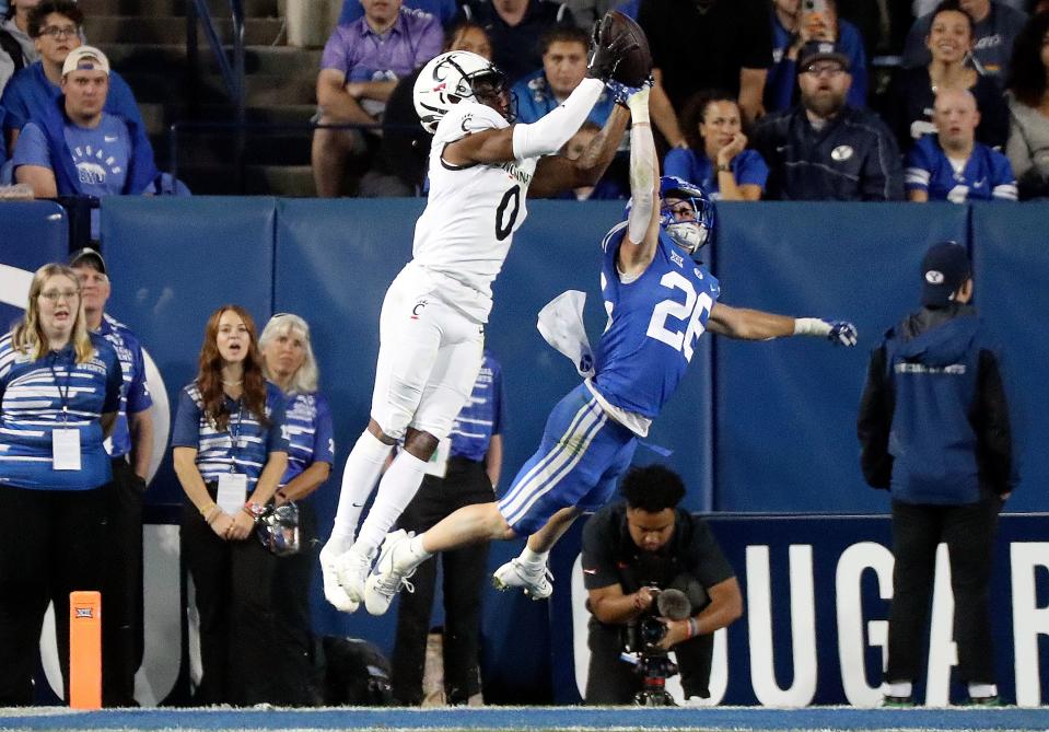 Cincinnati Bearcats wide receiver Braden Smith (0) scores a touchdown as Brigham Young Cougars safety Ethan Slade (26) reaches for the ball during the second half of a football game at LaVell Edwards Stadium in Provo on Friday, Sept. 29, 2023. BYU won 35-27. | Kristin Murphy, Deseret News