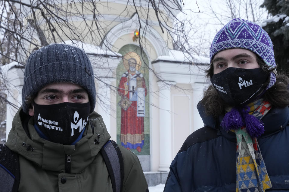 FILE - Supporters of the Memorial human rights group wearing face masks with the words "The Memorial cannot be banned!" gather in front of the Moscow Court in Moscow, Russia, Wednesday, Dec. 29, 2021. On Friday, Oct. 7, 2022 the Nobel Peace Prize was awarded to jailed Belarus rights activist Ales Bialiatski, the Russian group Memorial and the Ukrainian organization Center for Civil Liberties. (AP Photo/Alexander Zemlianichenko, File)