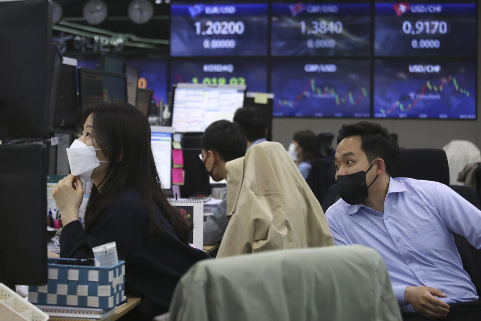 Currency traders watch monitors at the foreign exchange dealing room of the KEB Hana Bank headquarters in Seoul, South Korea, Friday, April 23, 2021. Asian stock markets were mixed Friday after Wall Street fell following a report that President Joe Biden will propose raising taxes on wealthy investors. (AP Photo/Ahn Young-joon)