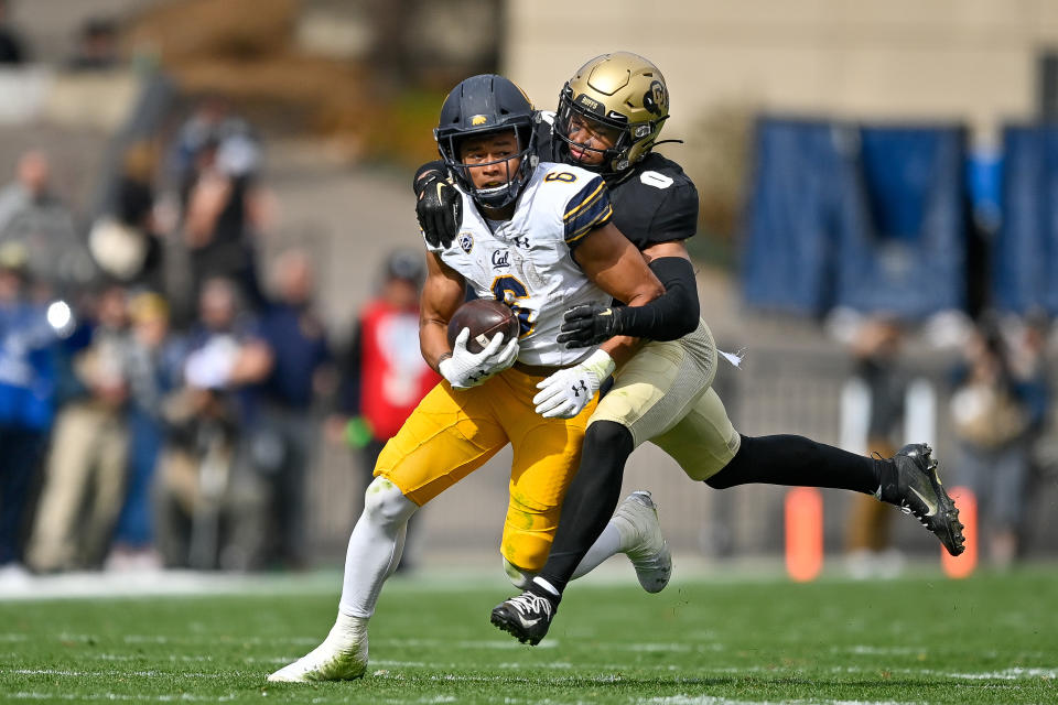 BOULDER, CO – OCTOBER 15: Running back Jaydn Ott #6 of the California Golden Bears carries the ball and is tackled by cornerback Kaylin Moore #0 of the Colorado Buffaloes at Folsom Field on October 15, 2022 in Boulder, Colorado. (Photo by Dustin Bradford/Getty Images)