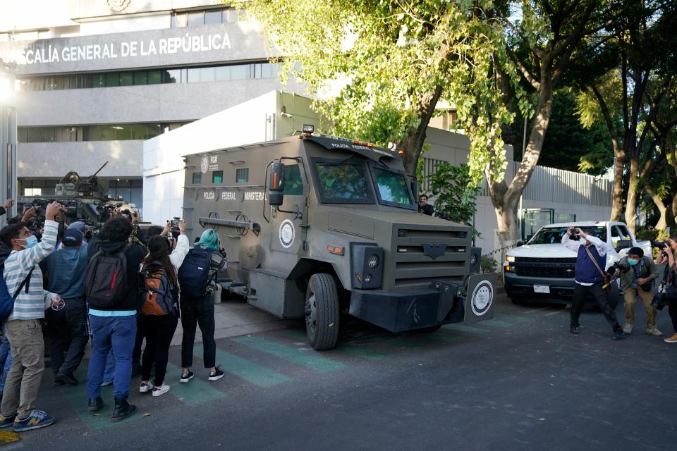 Members of the media make images as an armored transport drives out of the prosecutor's building where Ovidio Guzmán, one of the sons of former Sinaloa Cartel boss Joaquin "El Chapo" Guzmán, is in custody in Mexico City, Thursday, Jan. 5, 2023. The Mexican military has captured Ovidio Guzmán during an operation outside Culiacán, a stronghold of the Sinaloa drug cartel in western Mexico.