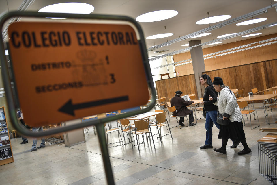 People arrive at a polling station to cast their votes for the general election in the small village of Tafalla, around 38 kms (23,6 miles) from Pamplona, Spain, Sunday, April 28, 2019. A divided Spain is voting in its third general election in four years, with all eyes on whether a far-right party will enter Parliament for the first time in decades and potentially help unseat the Socialist government. (AP Photo/Alvaro Barrientos)