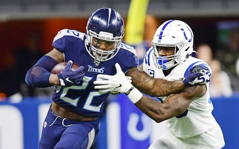 Tennessee Titans running back Derrick Henry (22) runs past Indianapolis Colts linebacker Darius Leonard (53) in the second half at Lucas Oil Stadium - Credit: USA Today