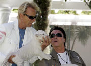 Siegfried Fischbacher, left, and Roy Horn, of the illusionist team Siegfried & Roy, play with a six-week-old white-striped tiger cub at their Las Vegas home, Thursday, June 12, 2008. The pair are welcoming five new tiger cubs to their exotic habitat on the Las Vegas Strip. Fischbacher said Thursday that working with the tigers is the perfect rehabilitation for Horn, who was critically injured when he was mauled by a 380-pound white Bengal tiger onstage in 2003. (AP Photo/Louie Traub)